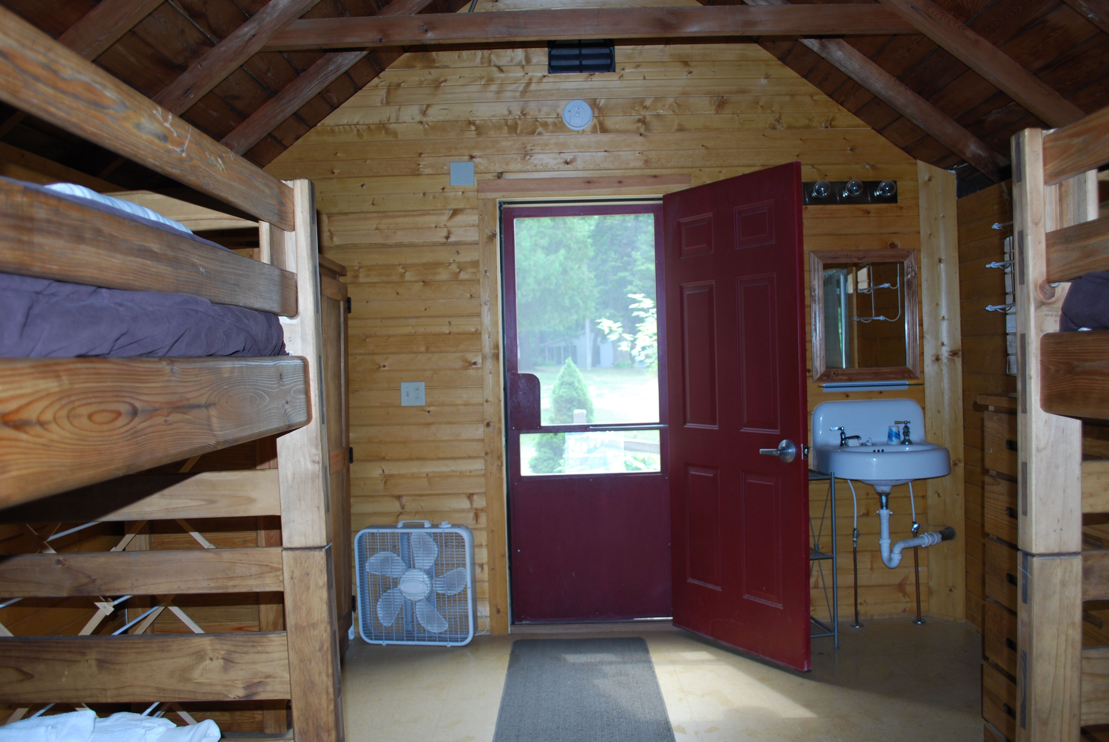 Inside of cabin on the hill room with bunkbeds from another angle